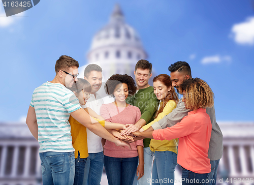 Image of international group of happy people holding hands