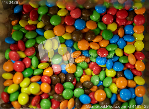 Image of close up of multicolored dragee candies in box