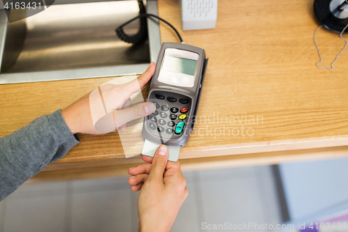 Image of close up of hand inserting bank card to terminal