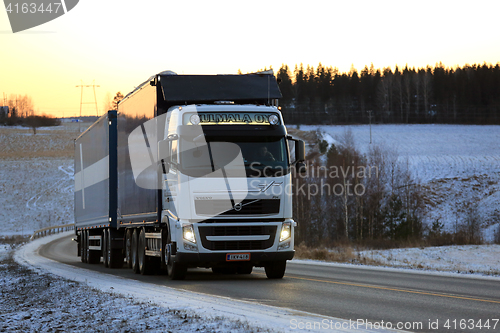 Image of White Volvo FH Combination Vehicle on Winter Sunset Road