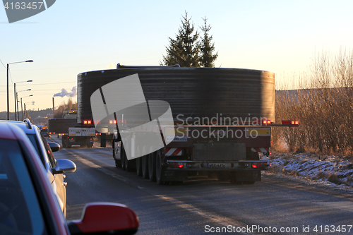 Image of Convoy of Wide Load Transports at Sunset