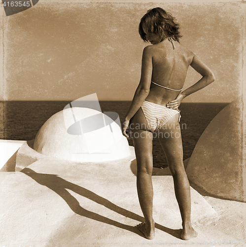 Image of retro girl stands on the beach