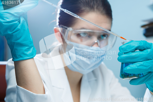 Image of Girl in goggles with flask