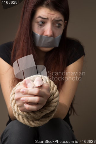 Image of Unhappy brunette with sealed mouth