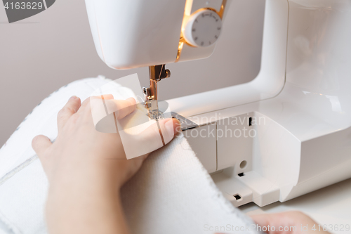 Image of Photo of woman with sewing-machine