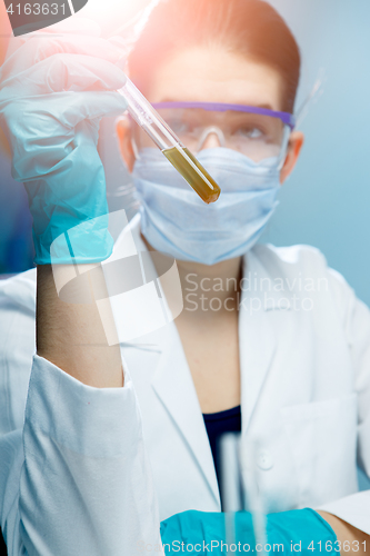 Image of Young researcher with test tubes