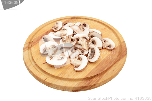 Image of Sliced chestnut mushrooms on a wooden chopping board