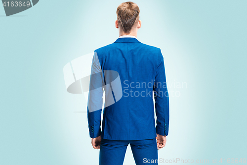 Image of The young stylish man in a suit. Rear view from the back.