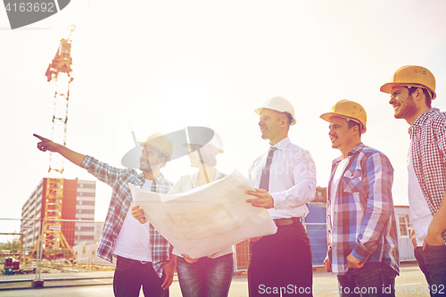 Image of group of builders and architects with blueprint