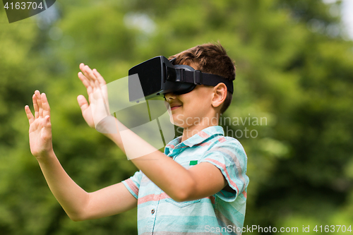 Image of boy with virtual reality headset outdoors