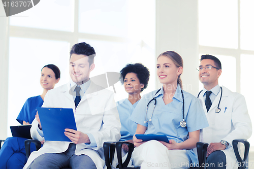 Image of group of happy doctors on seminar at hospital