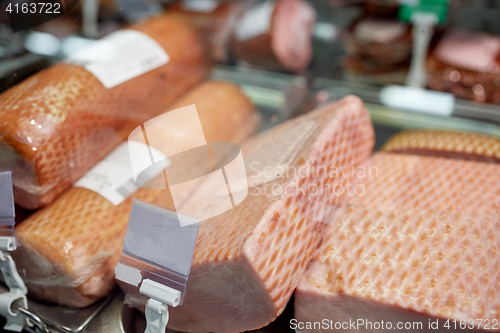 Image of ham at grocery store stall