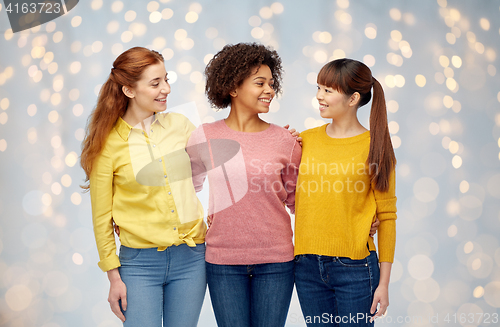 Image of international group of happy women over lights