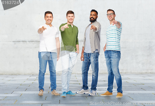 Image of happy smiling men pointing finger to you