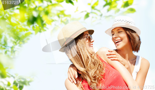 Image of happy women in hats over summer foliage background