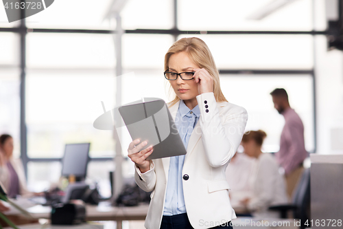 Image of businesswoman with tablet pc at office