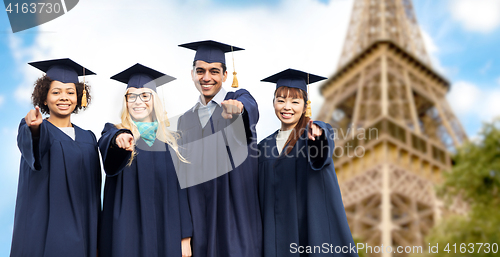 Image of happy bachelors pointing at you over eiffel tower