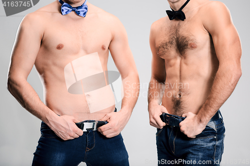 Image of The portrait of two fashion men with naked torso wearing butterfly tie