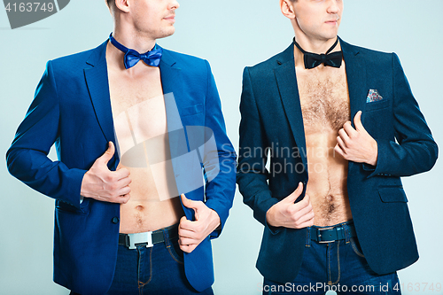 Image of The portrait of two fashion men with naked torso wearing butterfly tie