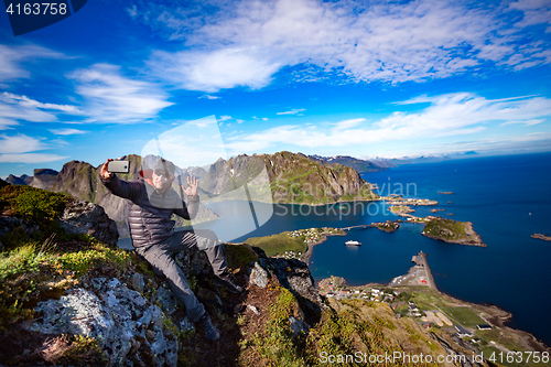 Image of Man on top of a mountain taking a selfie