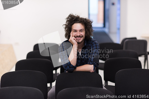 Image of A student sits alone  in a classroom