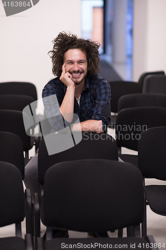 Image of A student sits alone  in a classroom