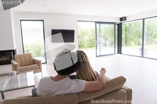 Image of Rear view of couple watching television