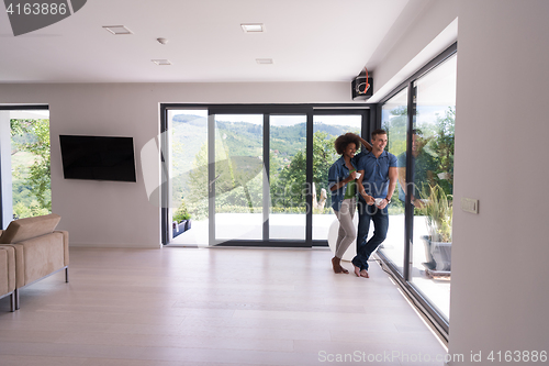 Image of romantic happy young couple relax at modern home indoors