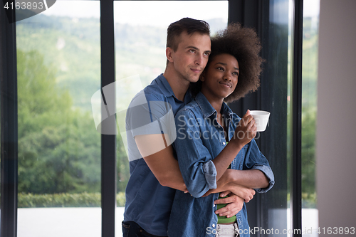 Image of romantic happy young couple relax at modern home indoors