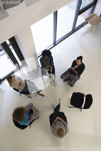 Image of Multiethnic startup business team on meeting  top view