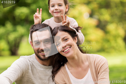 Image of happy family in summer park and having fun