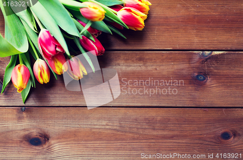 Image of close up of tulip flowers on wooden table