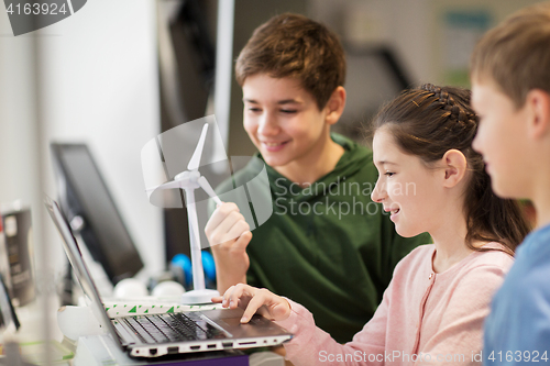 Image of children with laptop and wind turbine at school