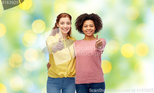 Image of happy smiling women showing thumbs up