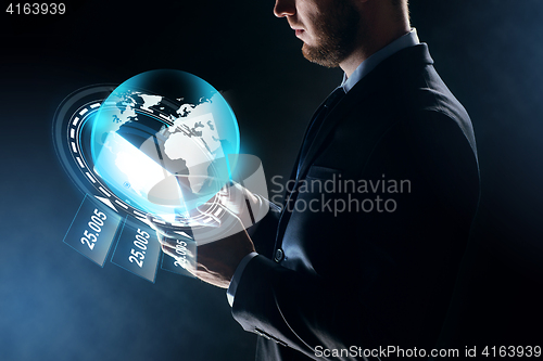 Image of businessman with tablet pc and earth hologram