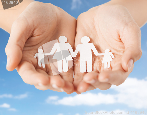 Image of close up of hands holding paper family pictogram