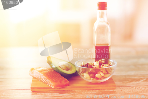 Image of close up of food and olive oil bottle on table