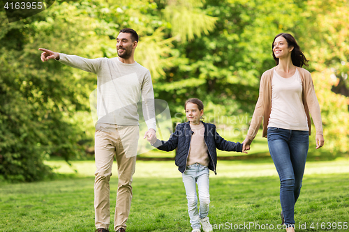 Image of happy family walking in summer park