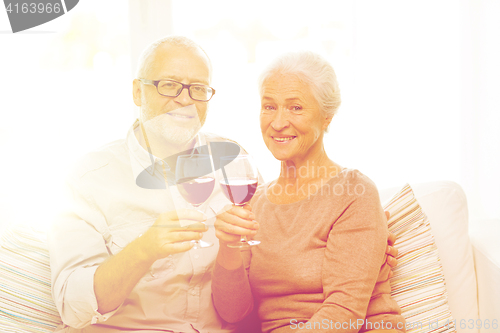 Image of happy senior couple with glasses of red wine