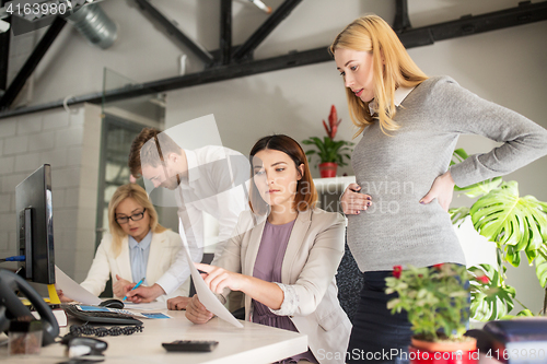 Image of business team with papers in office