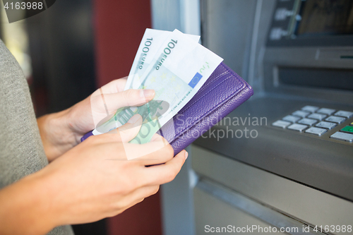 Image of close up of hand withdrawing money at atm machine