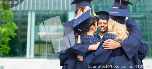 Image of happy students or bachelors hugging