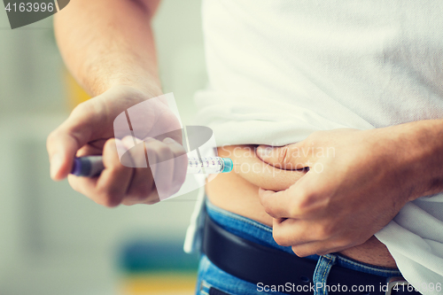 Image of man with syringe making insulin injection