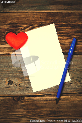 Image of valentines day. empty blank, blue pen and red heart