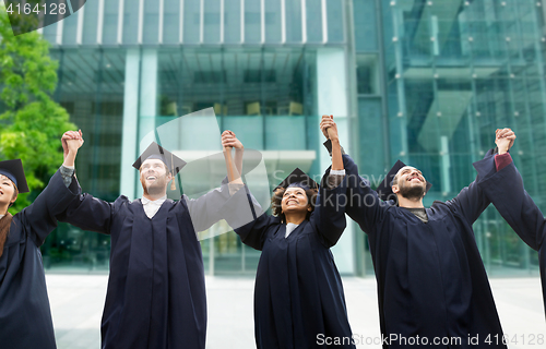 Image of happy students or bachelors celebrating graduation