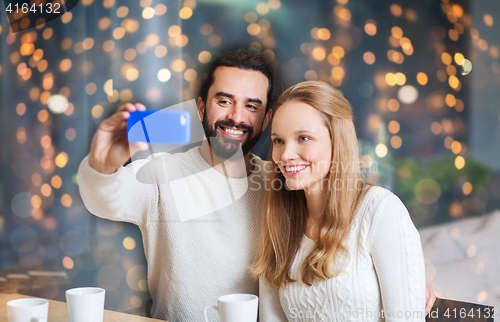 Image of happy couple with tablet pc and coffee at cafe