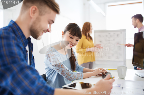 Image of creative team with tablet pc computer at office