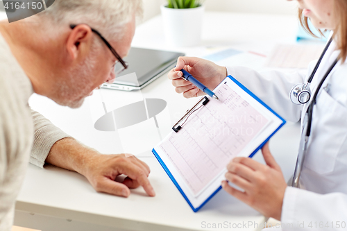 Image of doctor showing cardiogram to old man at hospital