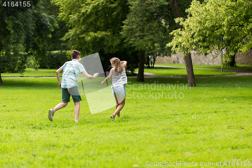 Image of group of happy kids or friends playing outdoors