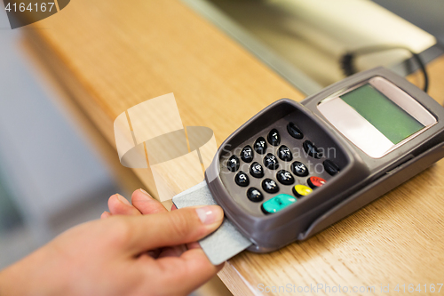 Image of close up of hand inserting bank card to terminal